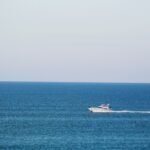 white and black boat on sea during daytime